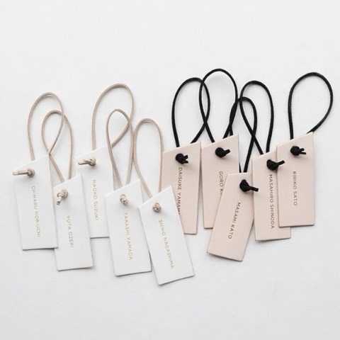 White and pale pink apparel hang tags with looped strings