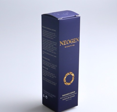 Tall dark blue perfume carton with gold details